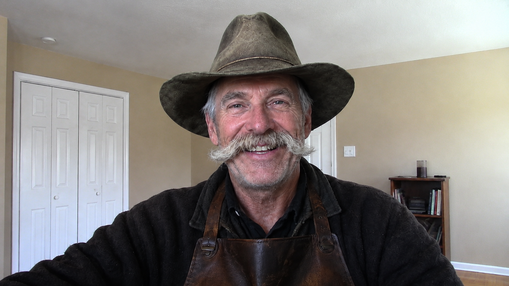 Andre The Fixer in a workshop apron and hat